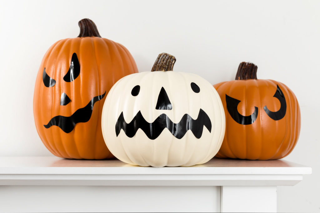 Pumpkins decorated as jack-o-lanterns for Halloween with permanent vinyl
