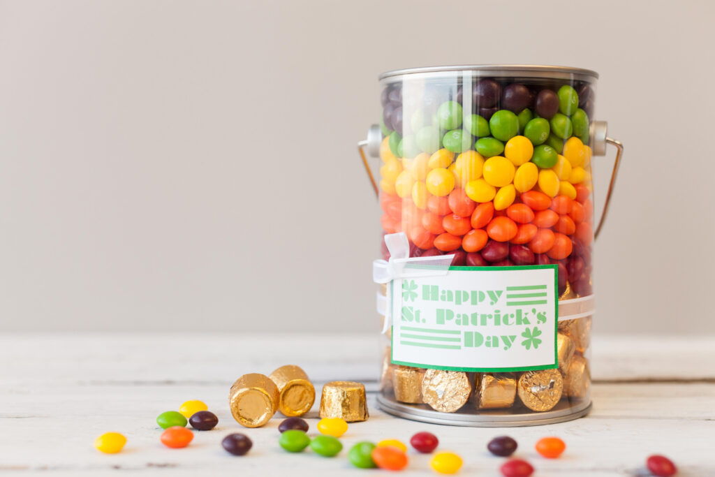 St. Patrick's Day bucket of candy in rainbow colors with labels made with Cricut