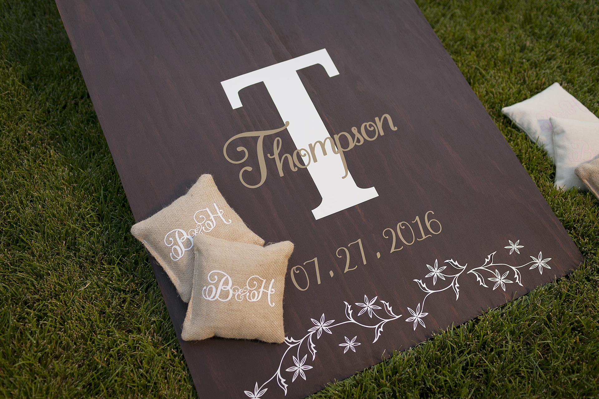 Cornhole board and bean bags with wedding date and last name