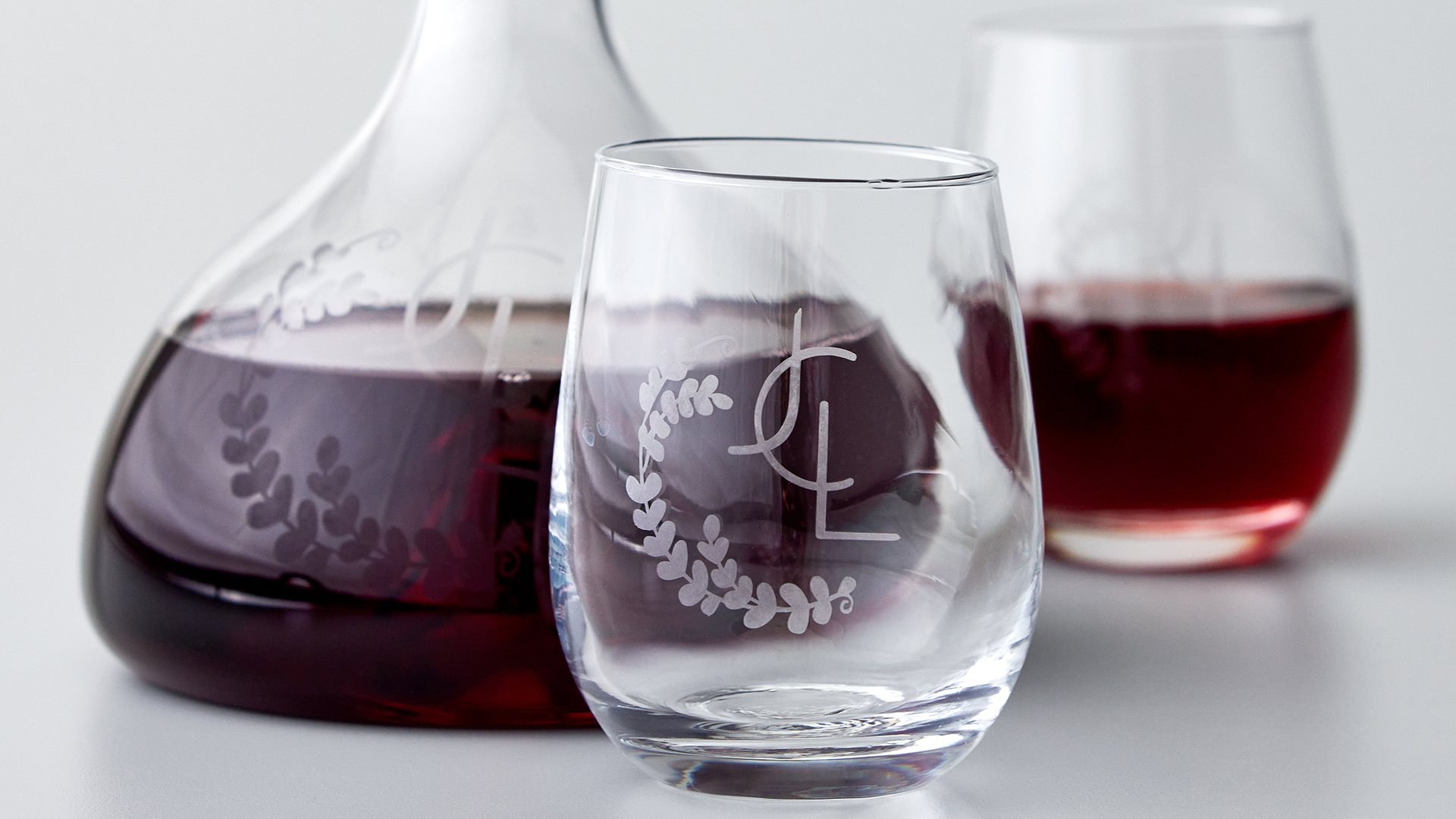 Wine glasses that are etched with initials and leaves