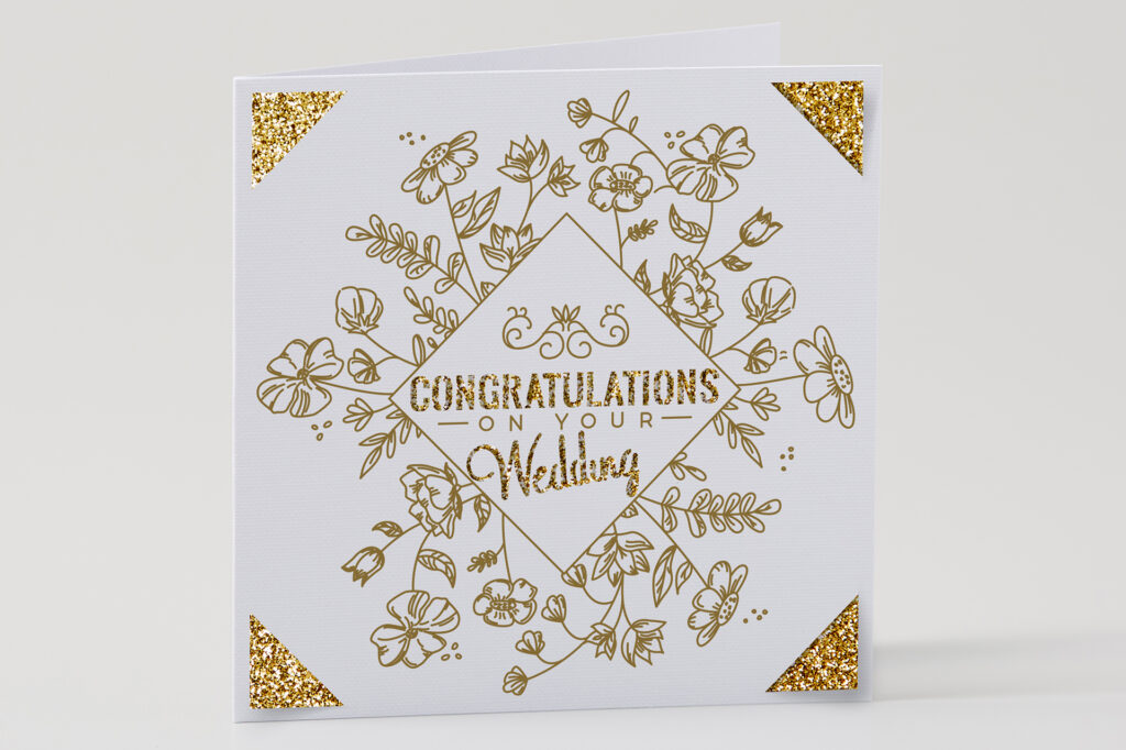 Card the says "congratulations on your wedding" in gold with a floral design around the words 