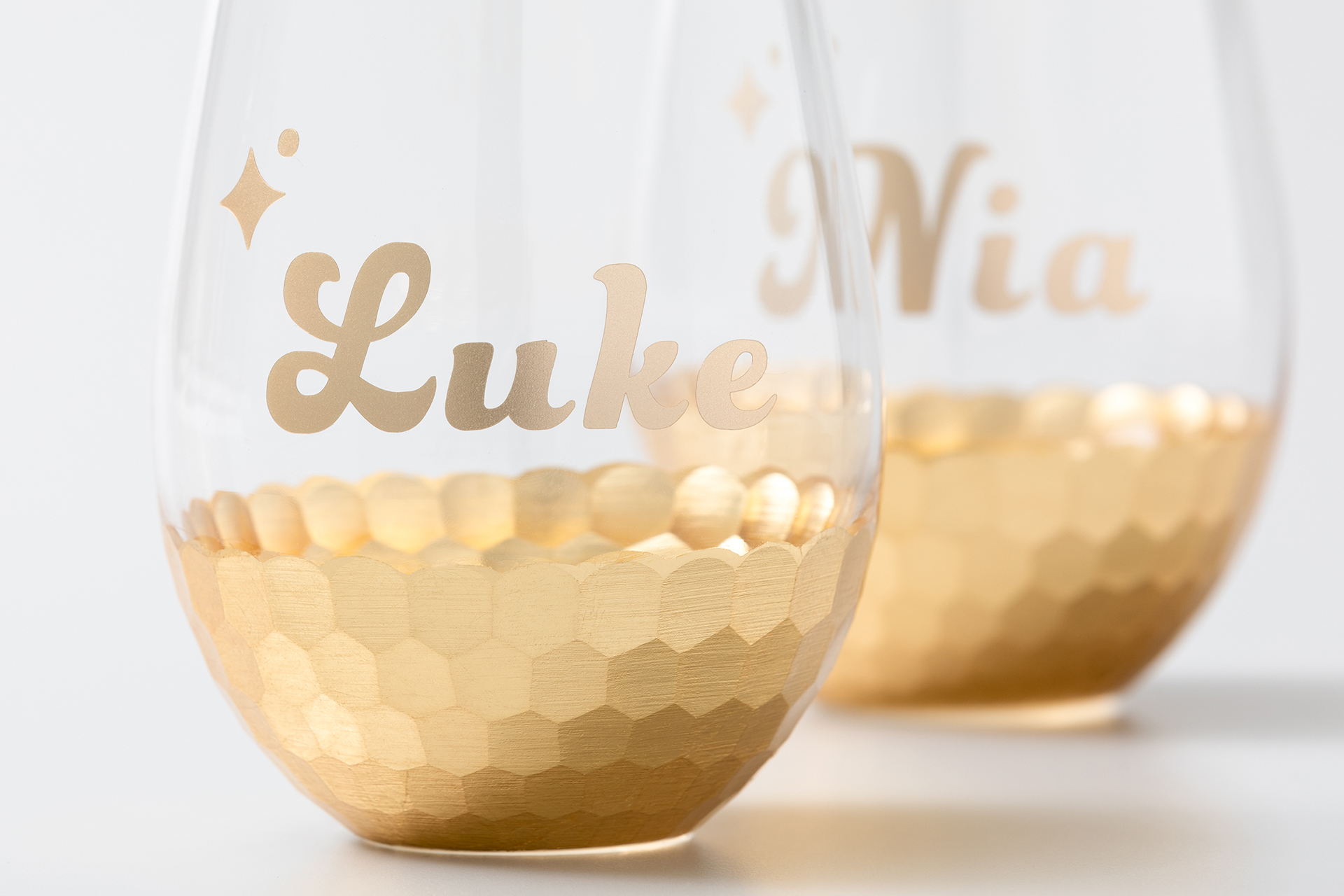 Wine glasses with gold on the bottom and names in gold vinyl