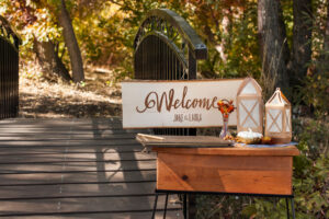 Rustic fall wedding welcome sign on entrance table