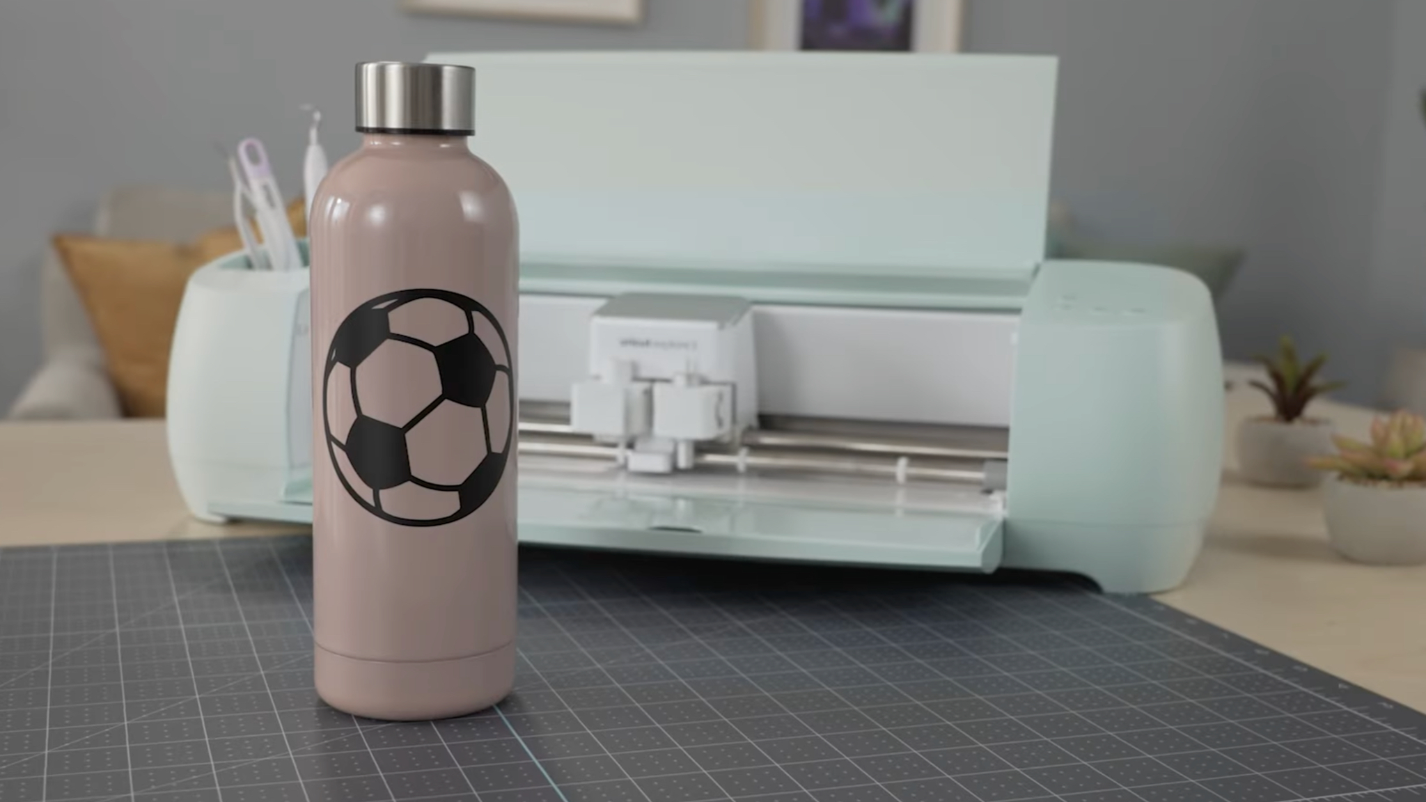 Water Bottole with vinyl decal in front of Cricut Explore 3