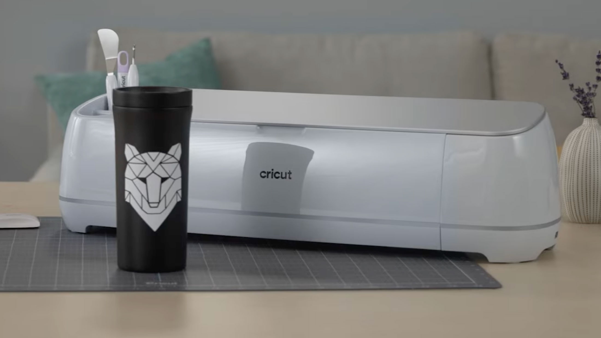 Water Bottole with vinyl decal in front of Cricut Maker 3