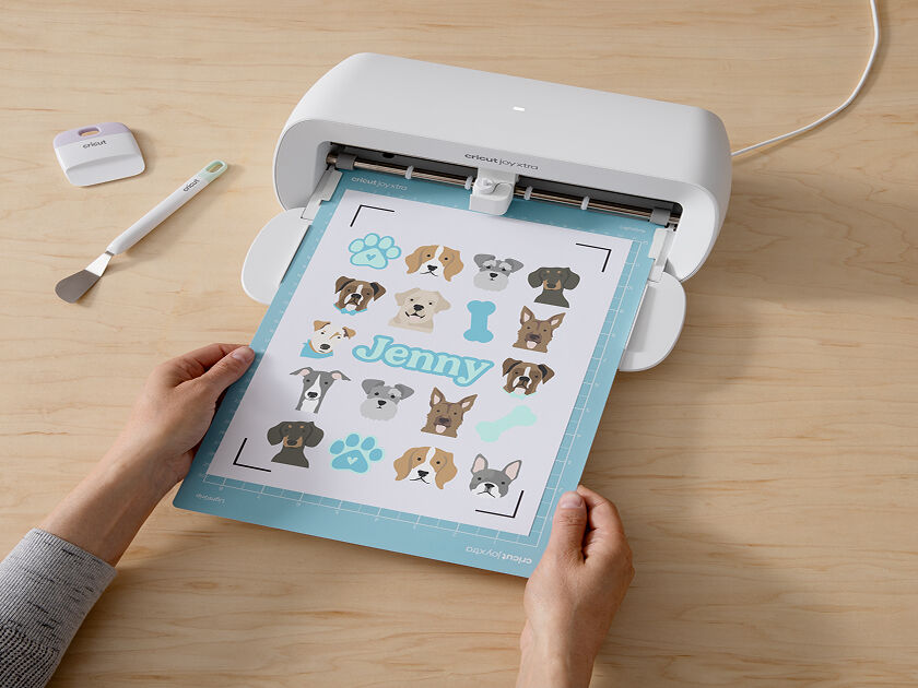 Woman's hand holding a smart phone with a personalized project template pulled up using Cricut's Design Space app