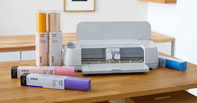 Cricut Maker 3 surrounded by various materials 
