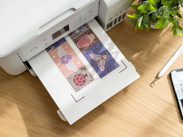 Woman's hand holding a smart phone with a personalized project template pulled up using Cricut's Design Space app