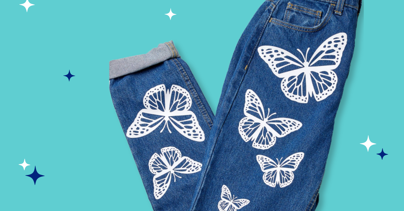 Jeans embellished with iron-on butterflies in white.