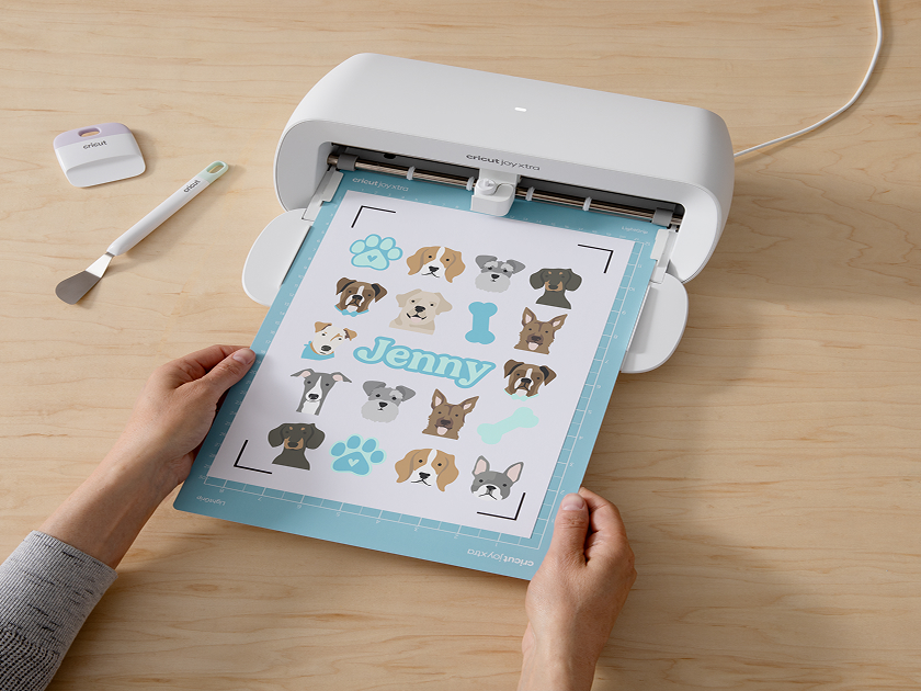 Woman's hand holding a smart phone with a personalized project template pulled up using Cricut's Design Space app
