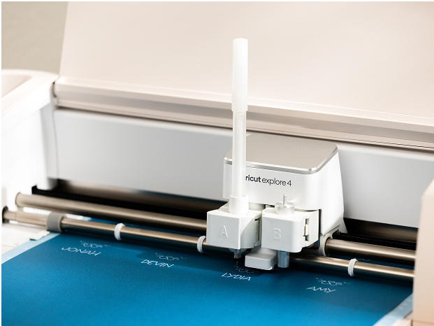 Cricut Explore 3 smart cutting machine cutting blue vinyl